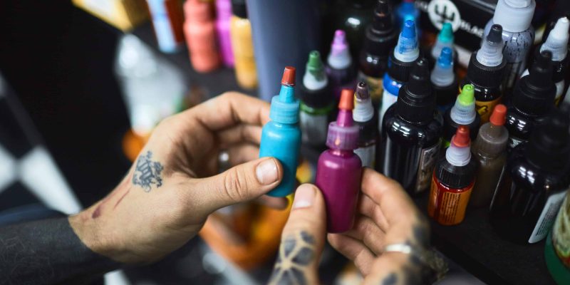 Tattooist choosing paints for new work